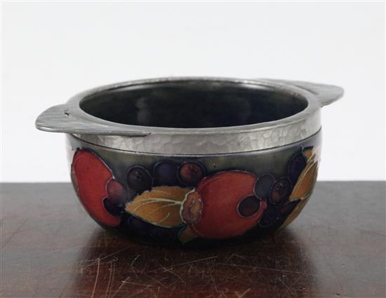 A Moorcroft pomegranate and Tudric pewter mounted quaich, 1920s, 13.8cm